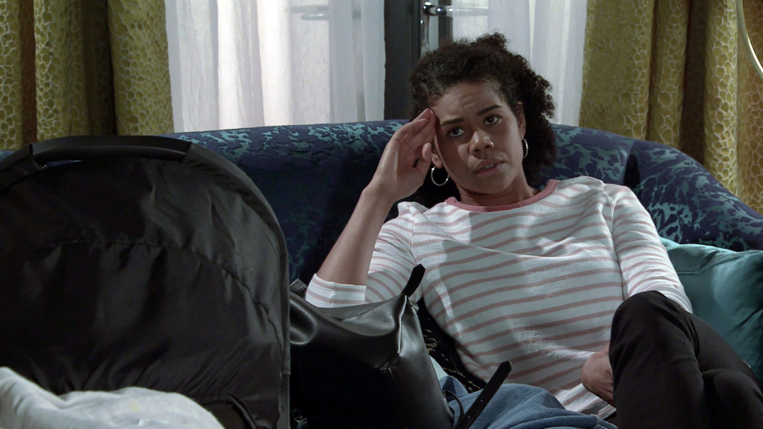 Coronation Street Grace sits on the sofa with her head in her hands