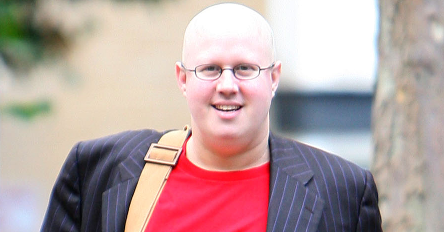 Matt Lucas before his weight loss wearing a red tshirt and pinstriped suit jacket