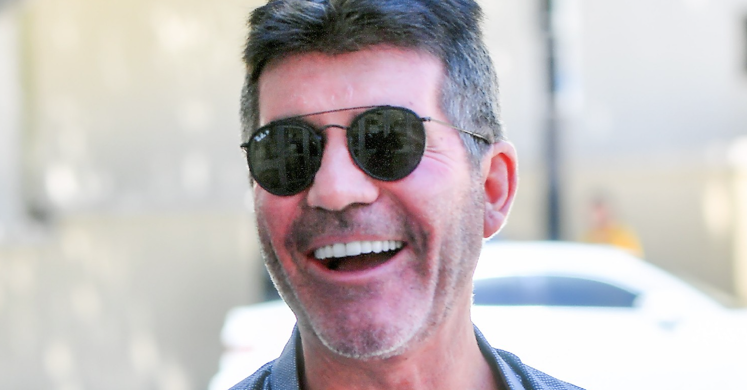 Simon Cowell grinning broadly in sunglasses