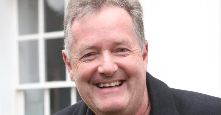 Piers Morgan smiling as he stands outside