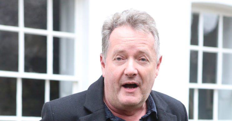 Piers Morgan standing outside a building