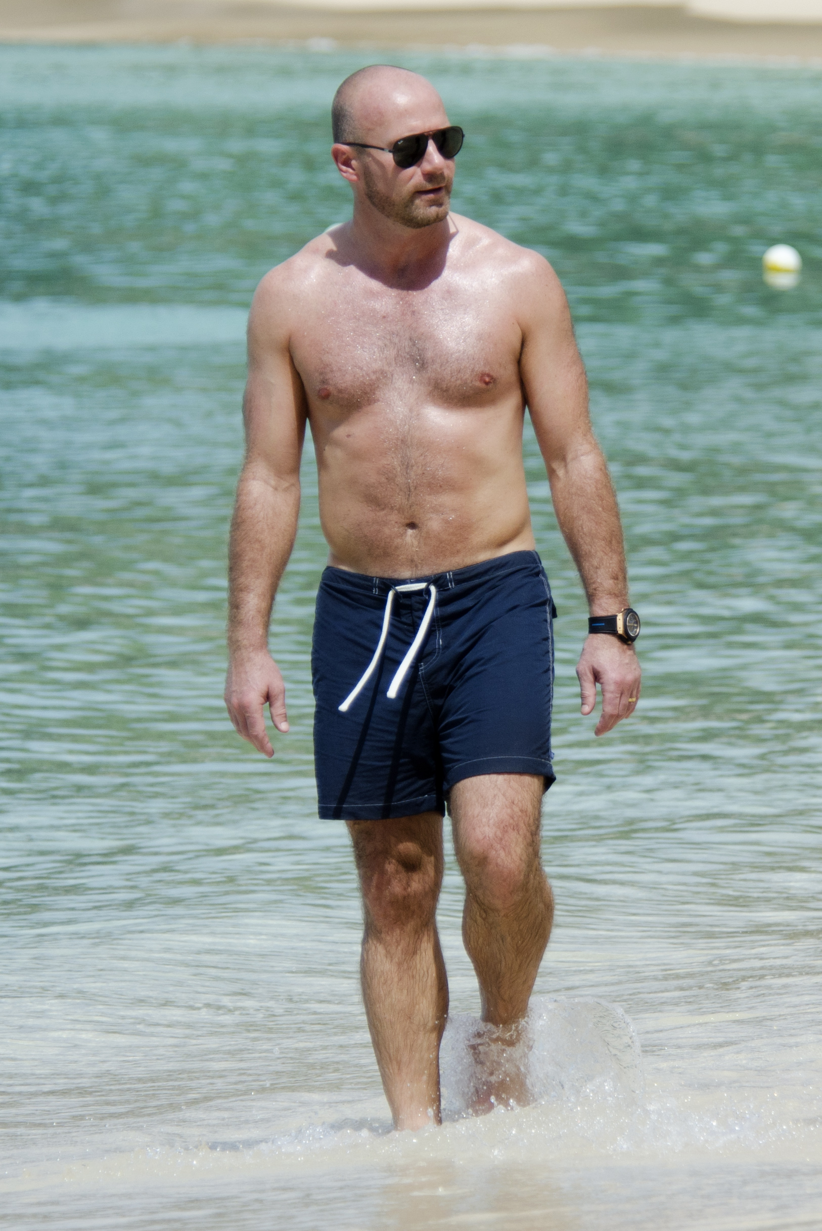 Alan Shearer topless on the beach 