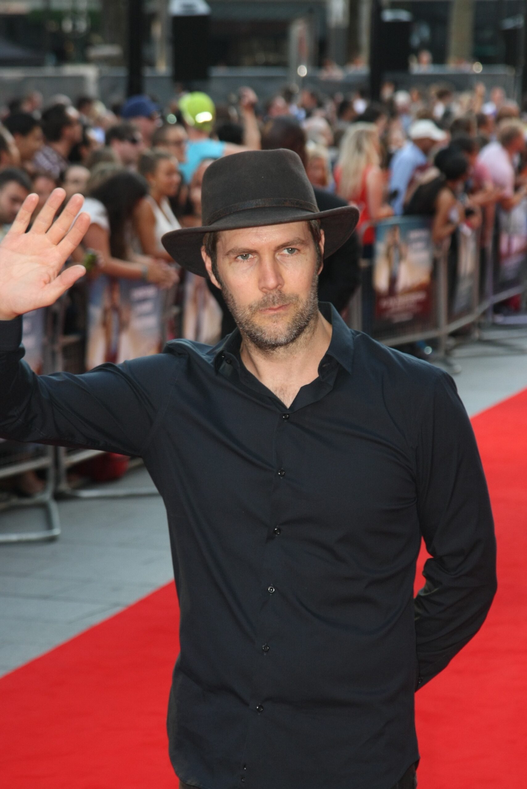 Rhod Gilbert waves to the camera and prepares for his new job on DIY SOS
