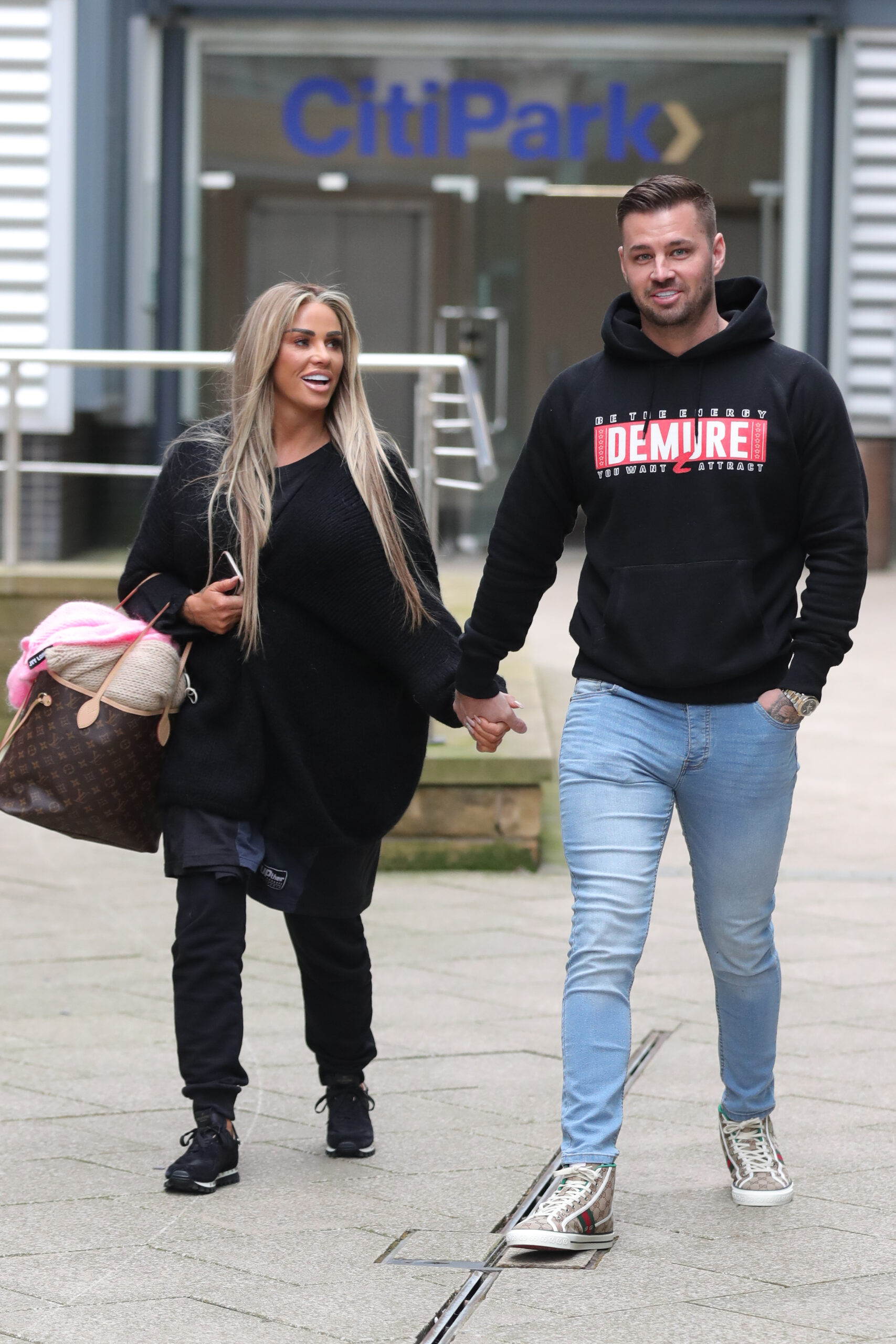 Katie Price And Carl Woods walk holding hands