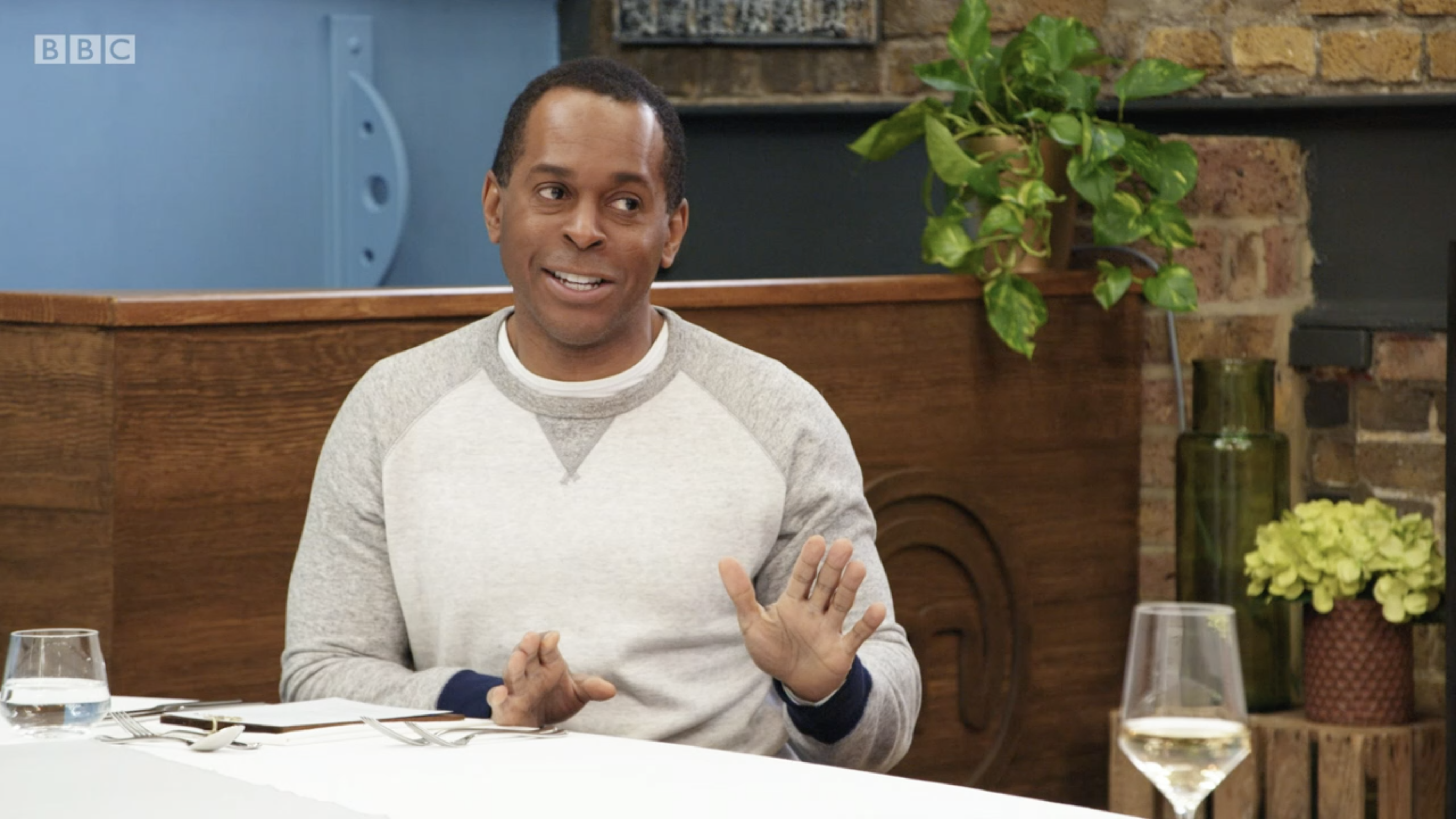 Andi Peters in a grey and white jumper on Celebrity masterchef sat at a table