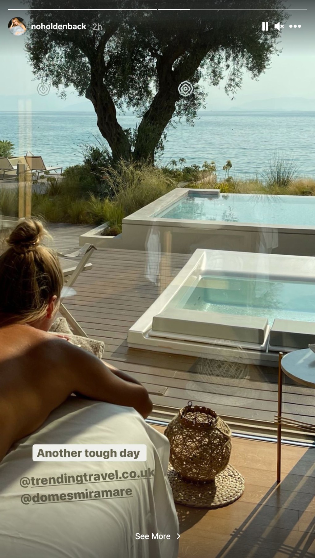 Amanda Holden lays topless on her fron on a sun lounger looking at te ocean in front of her in Instagram pic