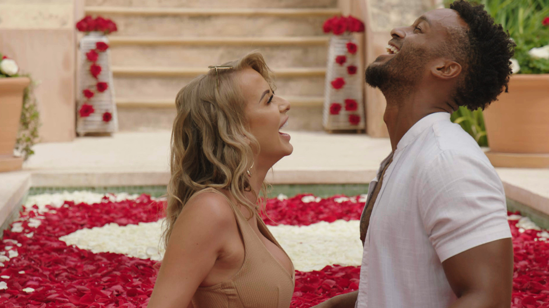 Love Island 2021 finalists Faye Winter and Teddy Soares laugh in a bath of roses 