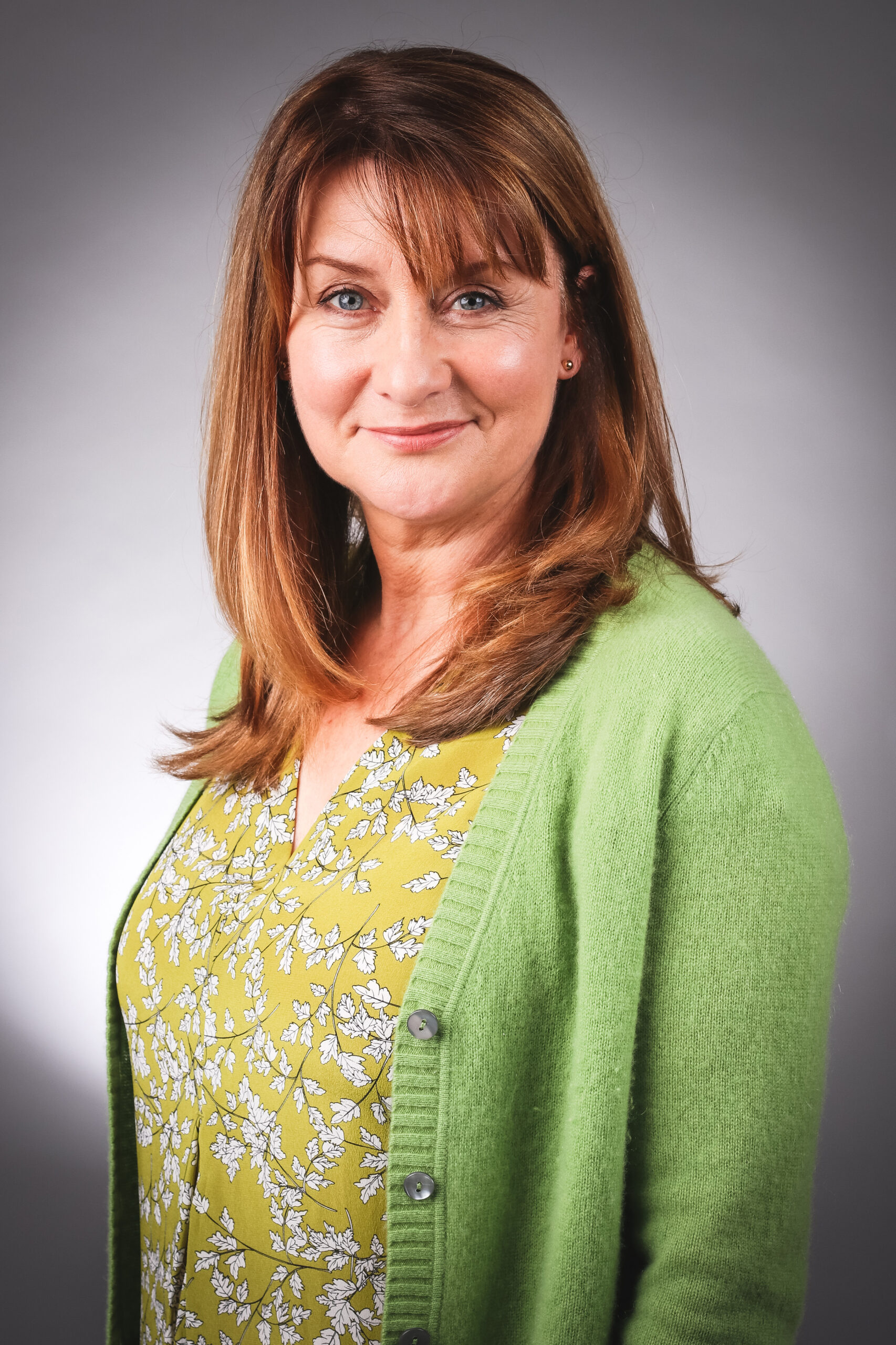 Susan Cookson poses in a green top and cardigan as Emmerdale's Wendy Posner 