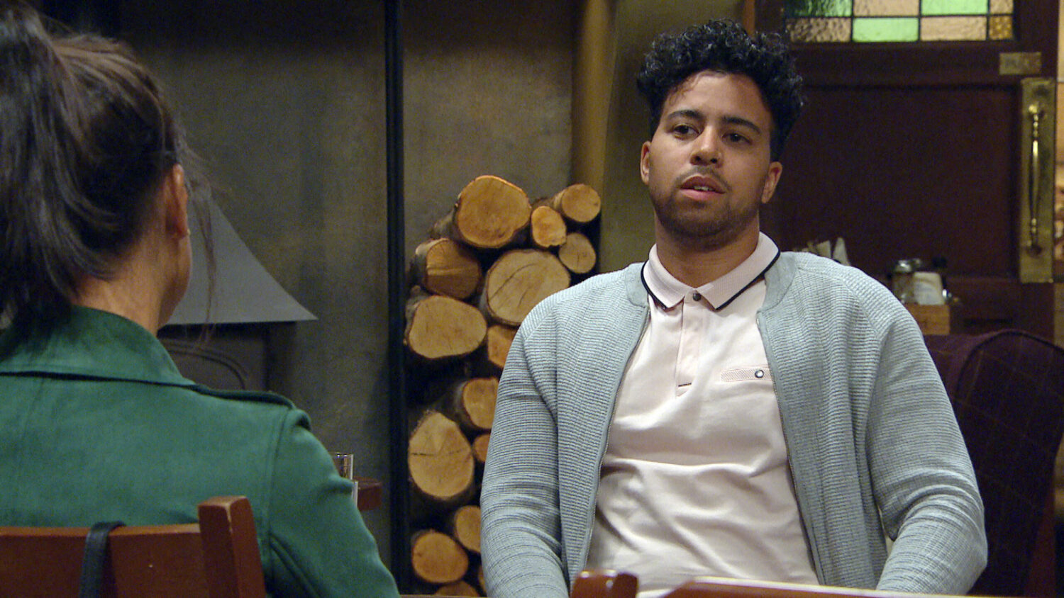Ellis in Emmerdale looks suspicious as he talks to Priya in the Woolpack