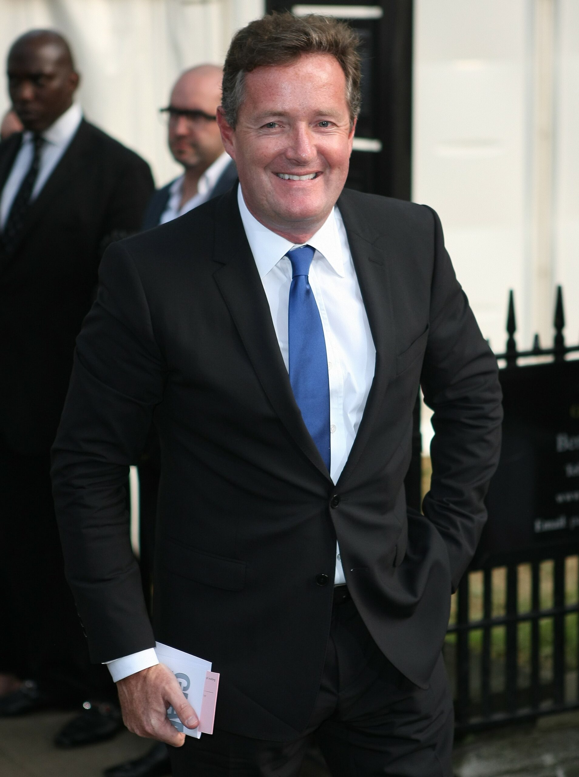 Piers Morgan smiles for cameras during public appearance