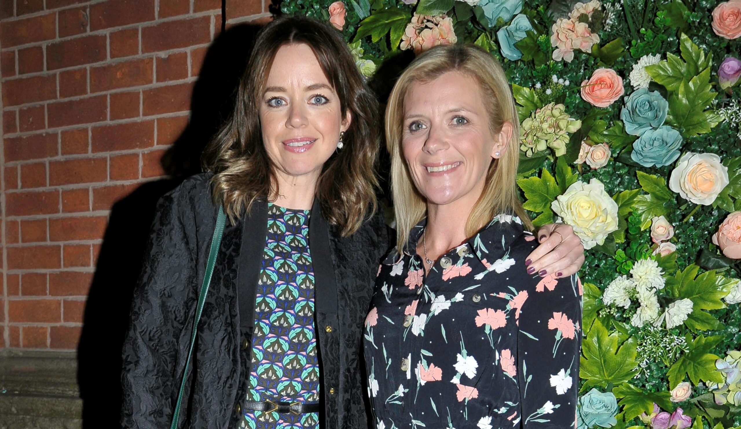 Georgia Taylor and Jane Danson pose in front of the flower wall at Katie McGlynn's leaving party