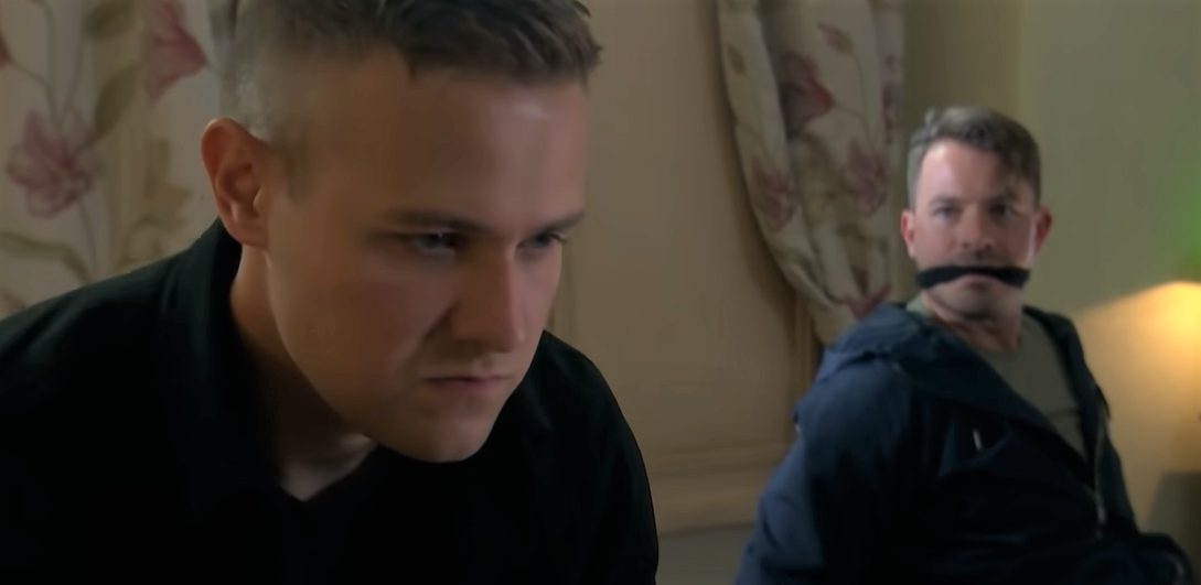 Ethan looks serious after kidnapping a scared Darren in Hollyoaks