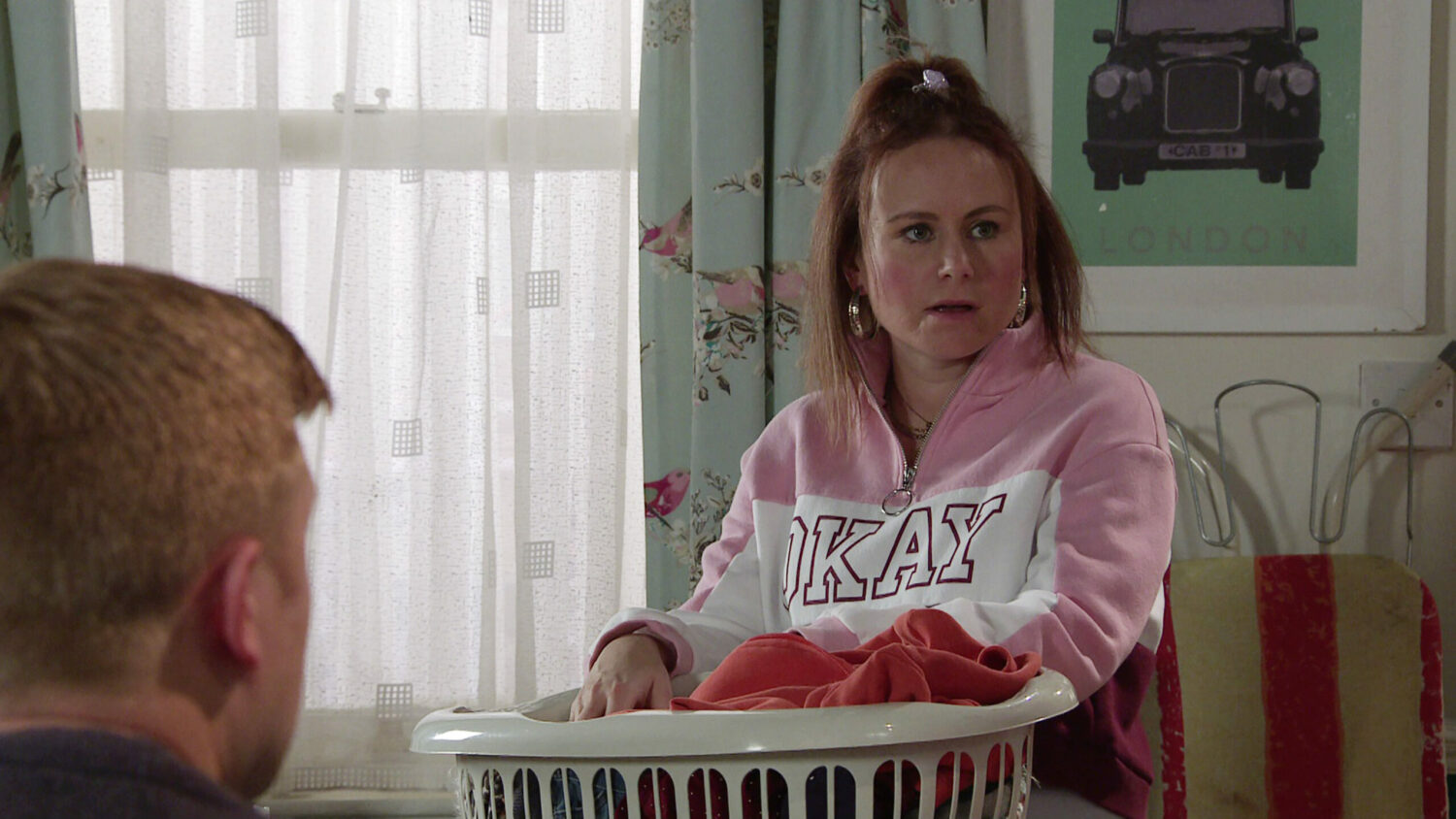 Gemma Winter looks annoyed as she sorts washing