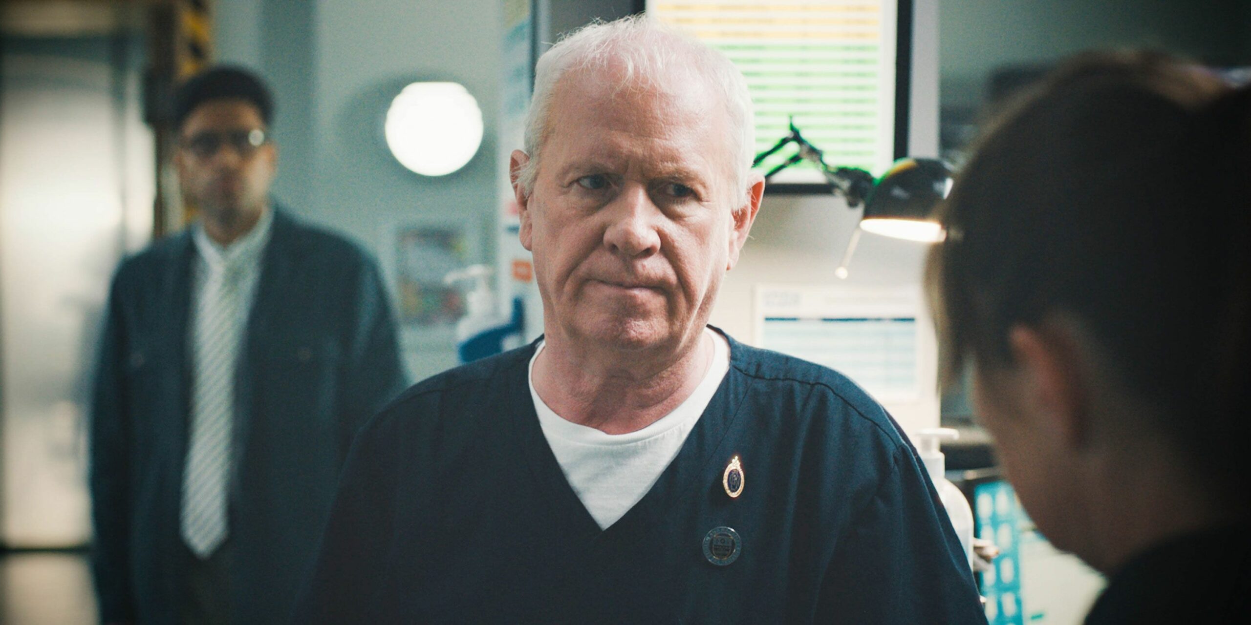 Charlie looking sternly at a colleague in Casualty (Credit: BBC)