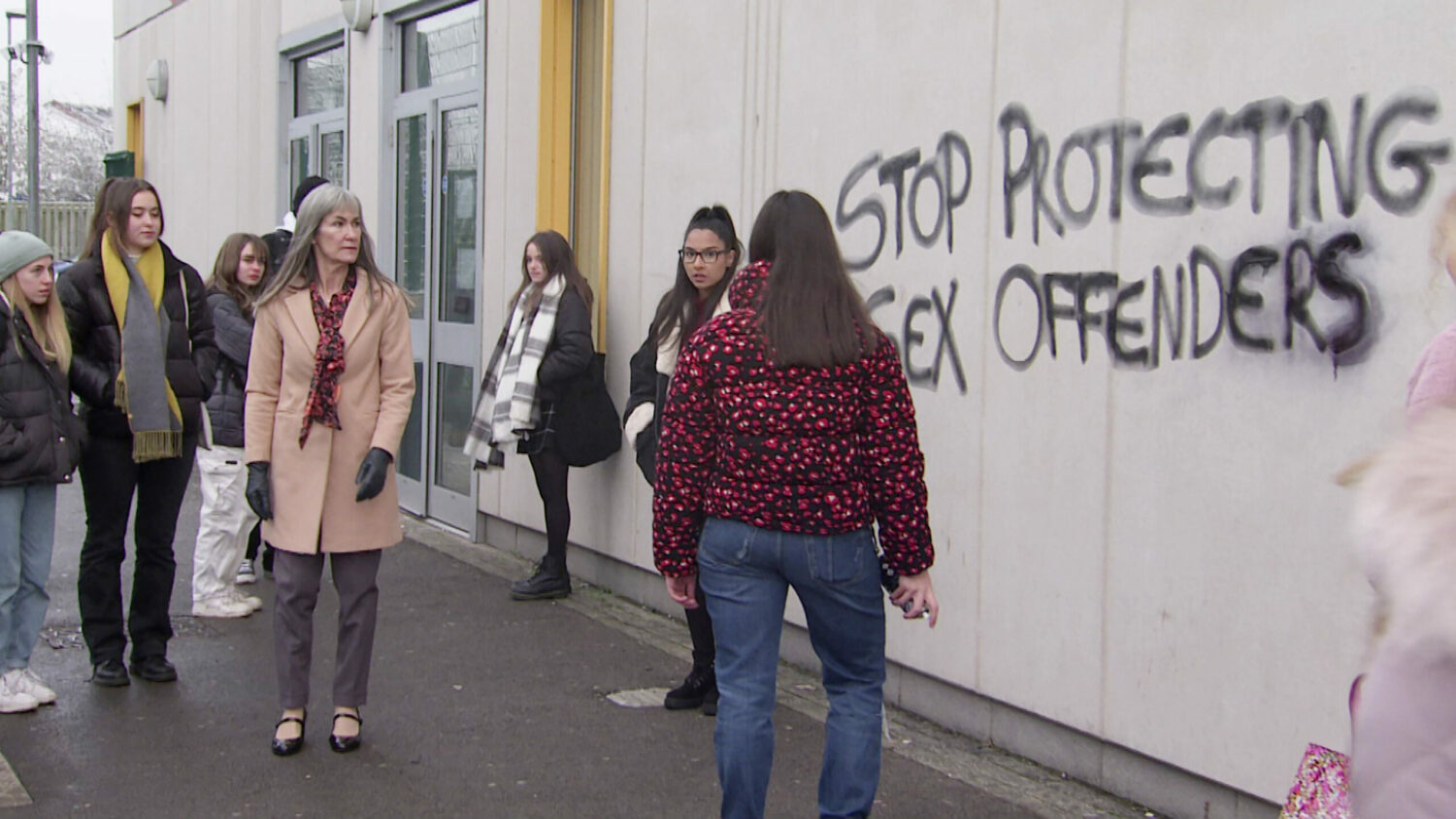 Coronation Street spoilers Jan 17 a crowd gathers to watch Amy spray painting the words ‘Stop Protecting Sex Offenders’ onto the side of a building.