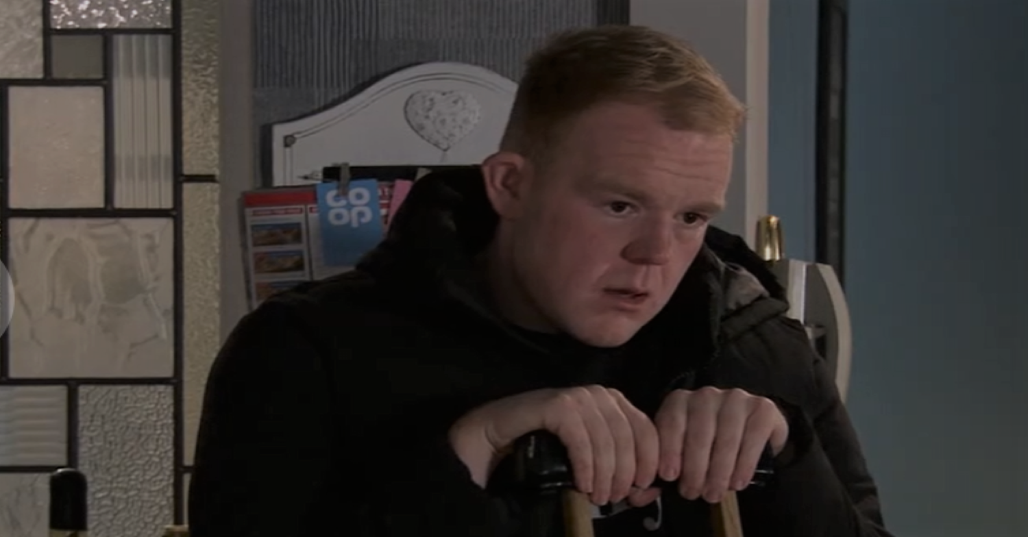 Coronation Street Craig looks deep in thought as he leans on his crutch