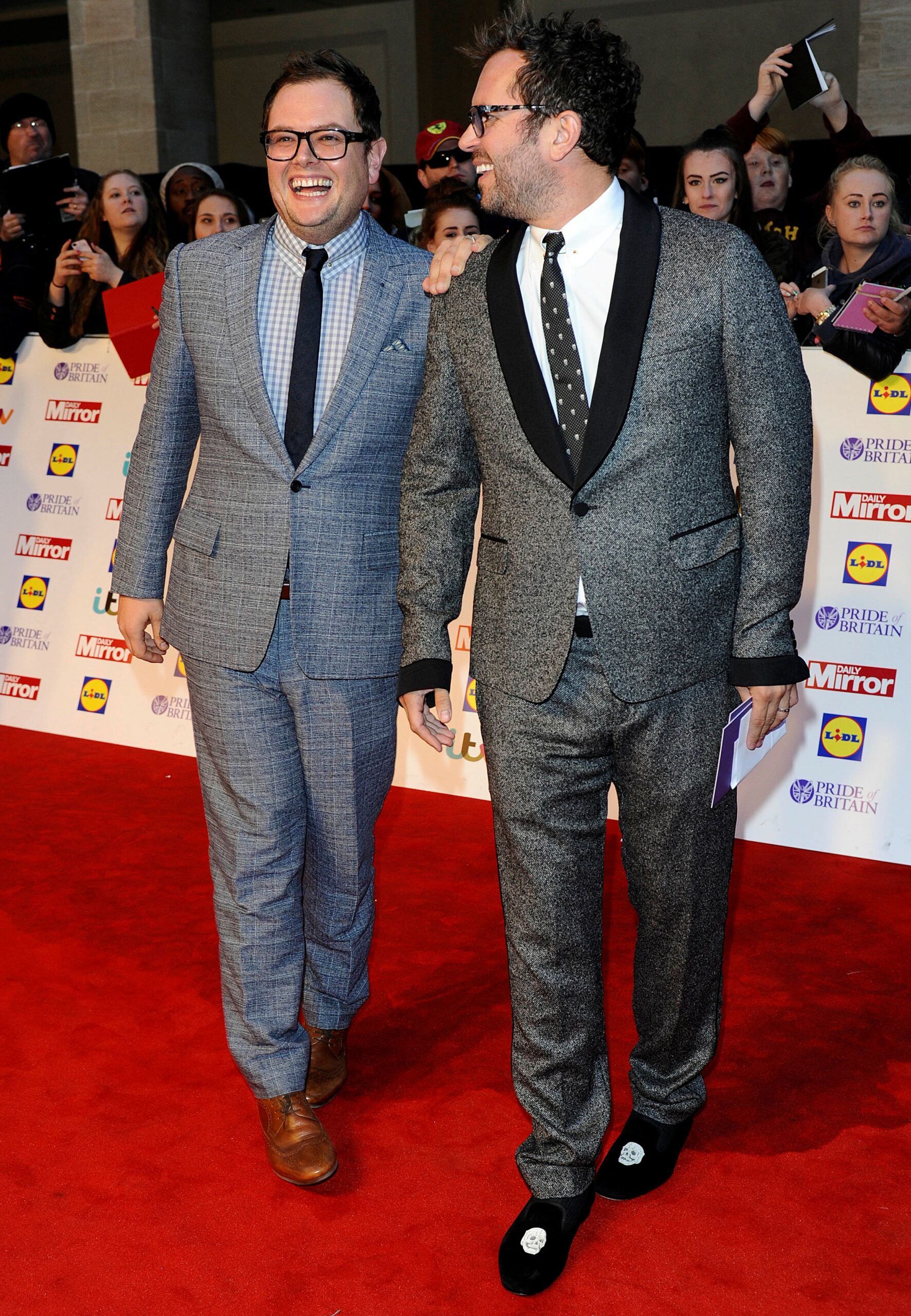 Alan Carr and husband Paul Drayton smiling on the red carpet
