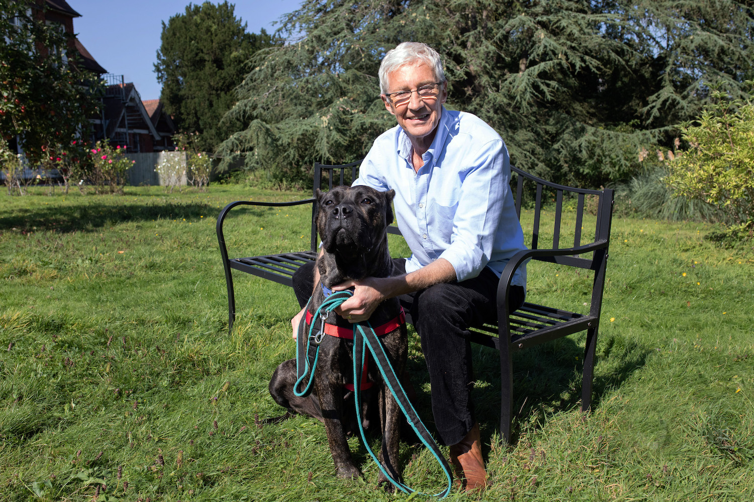 Paul O'Grady sits in the sunshine during an episode of For The Love Of Dogs
