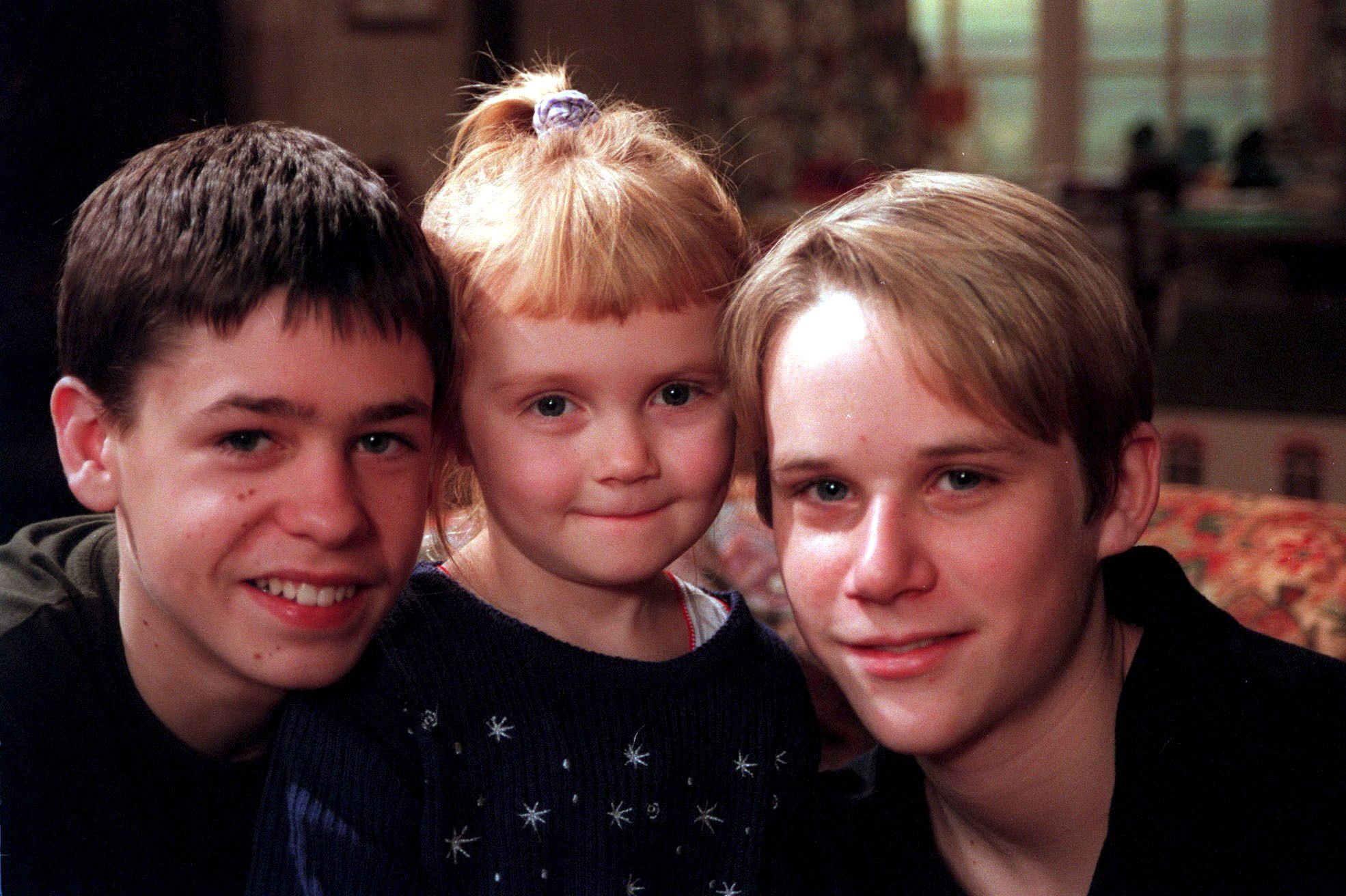 Emmerdale Andy Sugden Victoria Sugden and Robert Sugden smile in a family shot