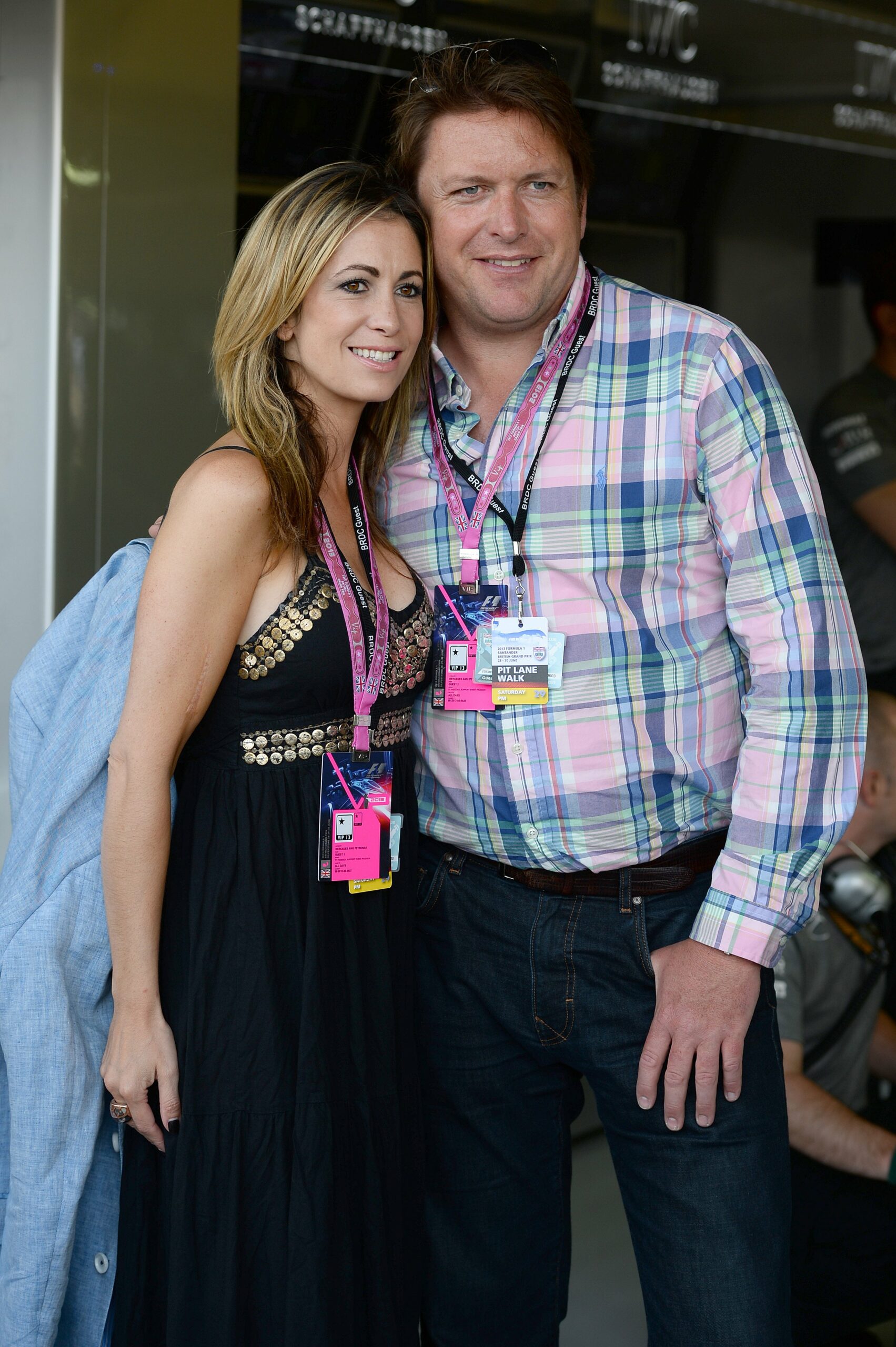 James Martin and long-term partner Louise Davies smile for the cameras at a Formula One event