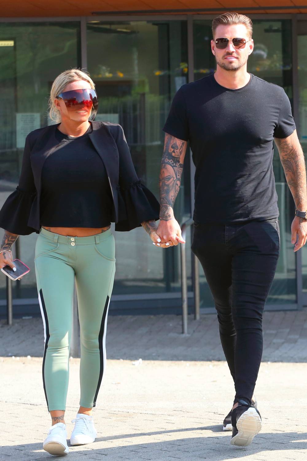 Katie and Carl holding hands outside court this month