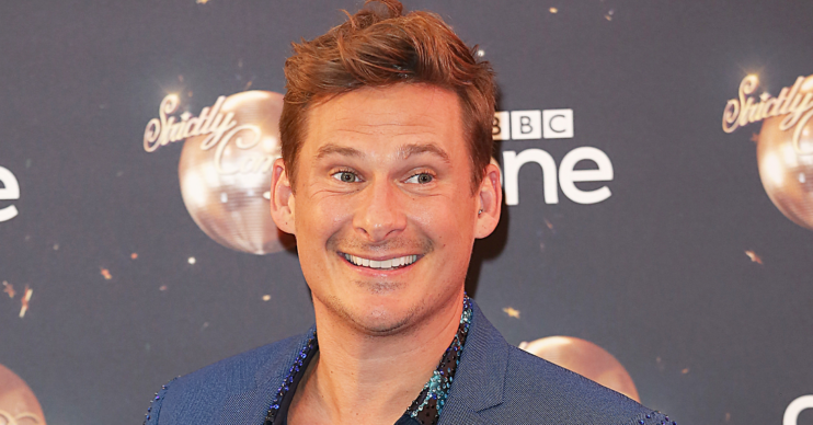 Lee Ryan smiling in a sparkly suit