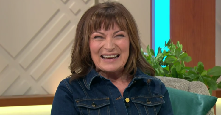 Lorraine Kelly laughing in a denim dress