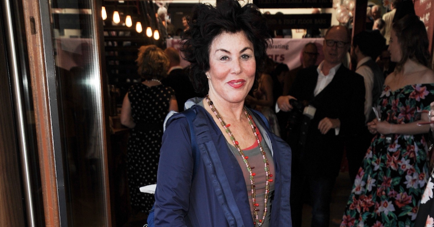 Ruby Wax smiling in a blue cardigan
