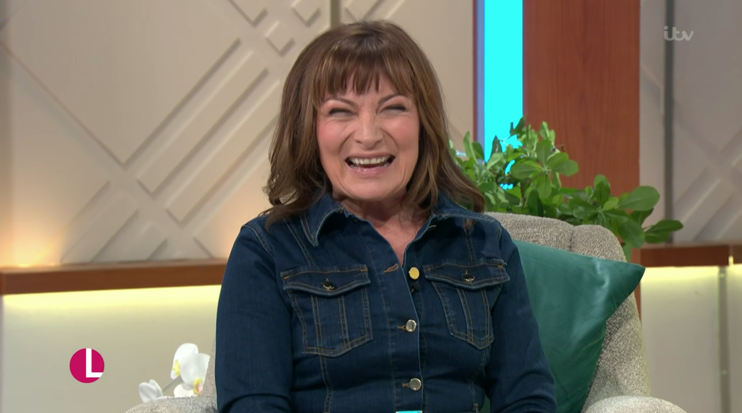 Lorraine Kelly laughing in a denim dress