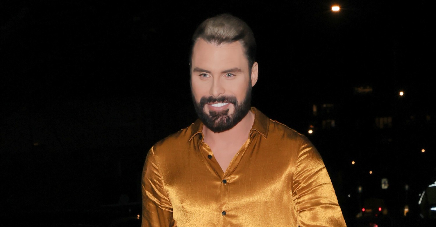 Rylan Clark wearing a gold shirt, walking at night time