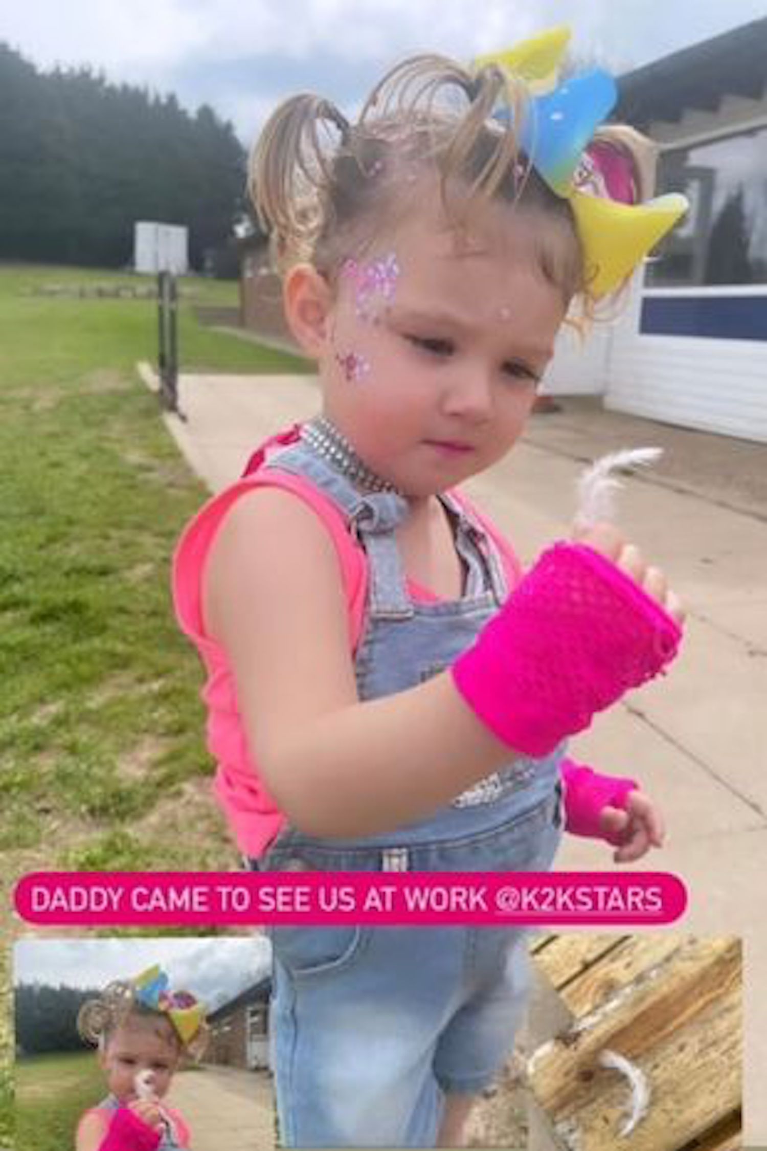 Tom Parker's daughter looking at a feather 'from Daddy'
