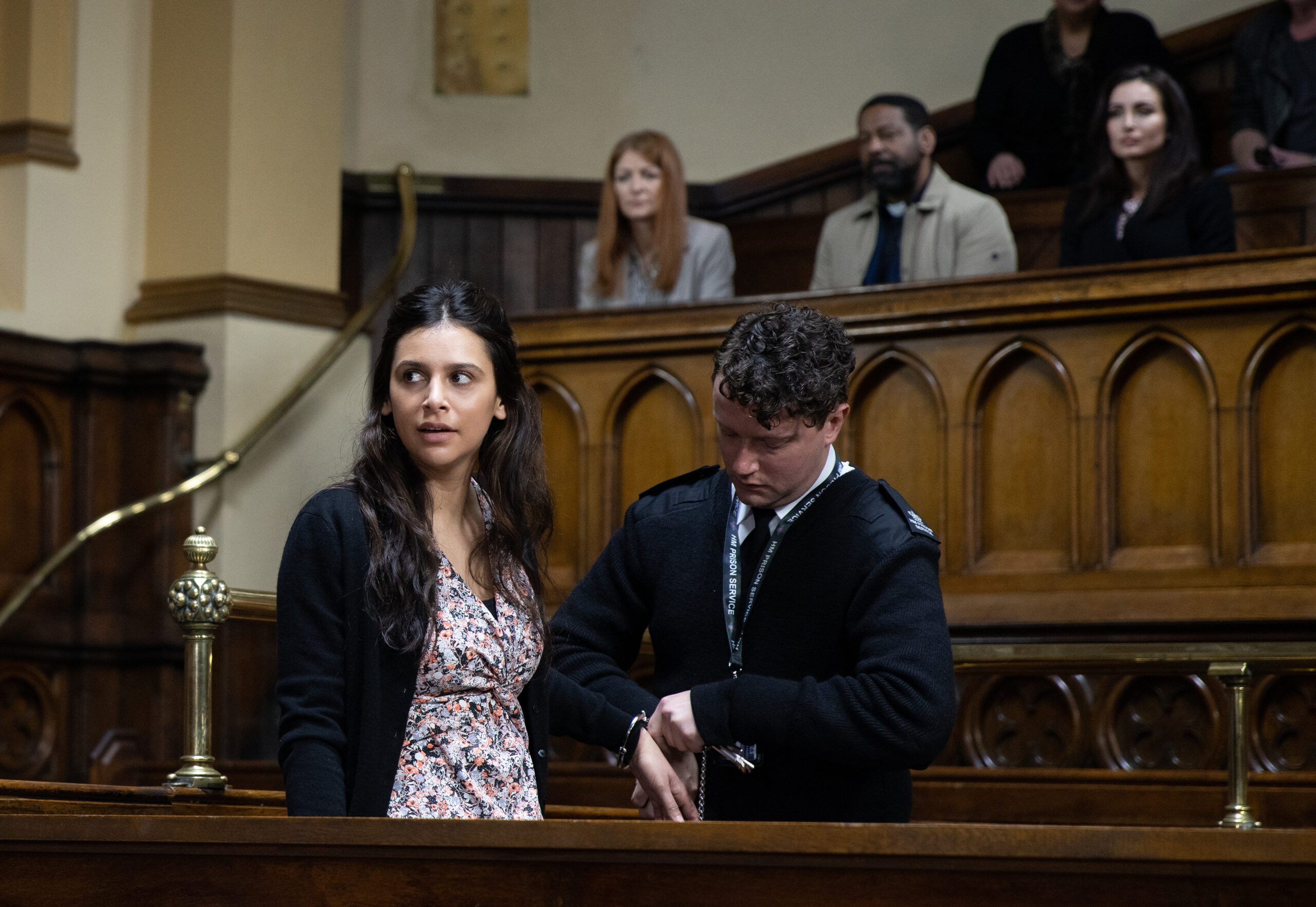 Meena being handcuffed by prison guard Ian in court in Emmerdale 