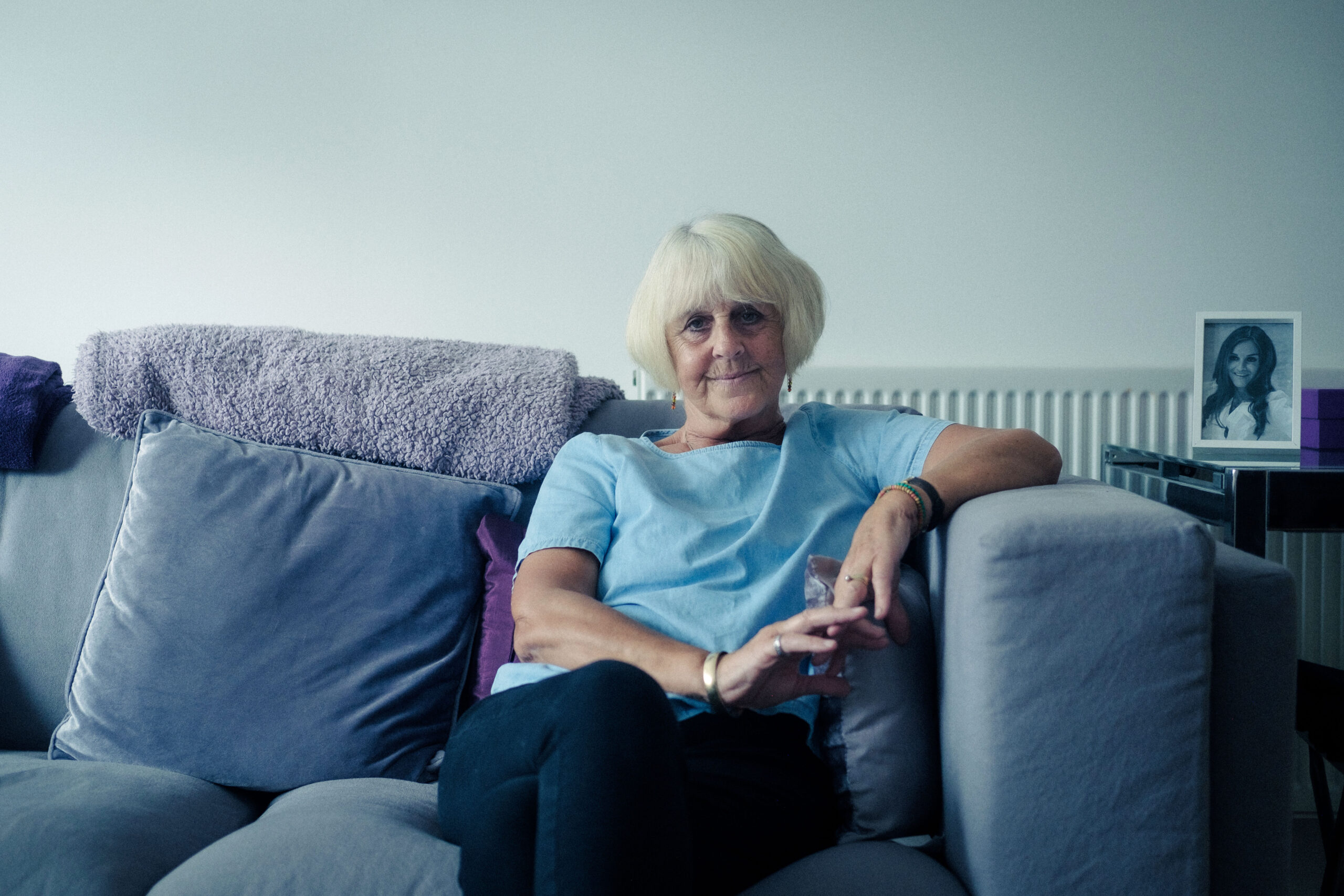Nikki Grahame's mum sitting on a sofa looking sad
