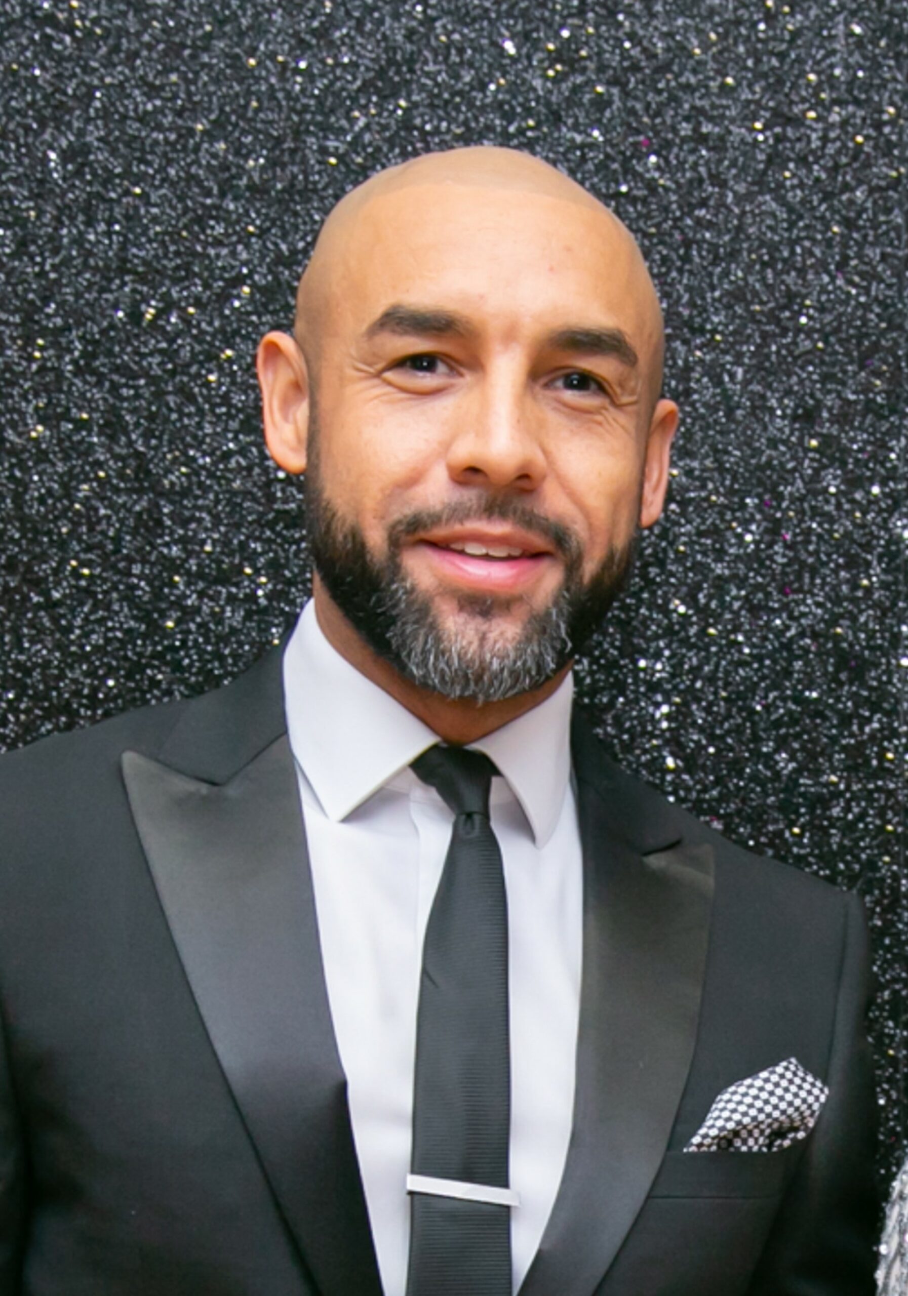 Alex Beresford smiles in black suit at MBCC Awards Presentation