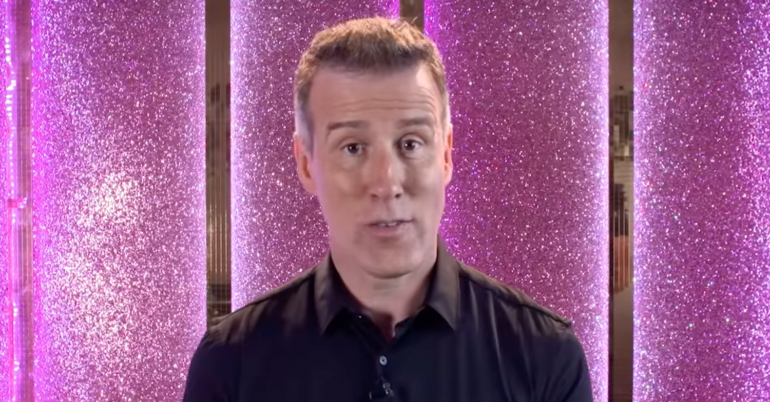 Strictly Come Dancing star Anton Du Beke stating in front of a pink glitter wall