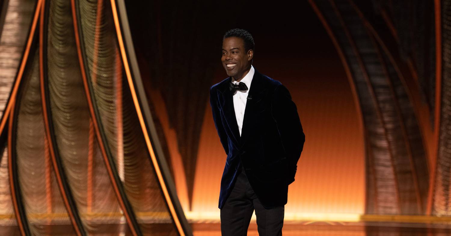 Chris Rock standing on stage at the Oscars