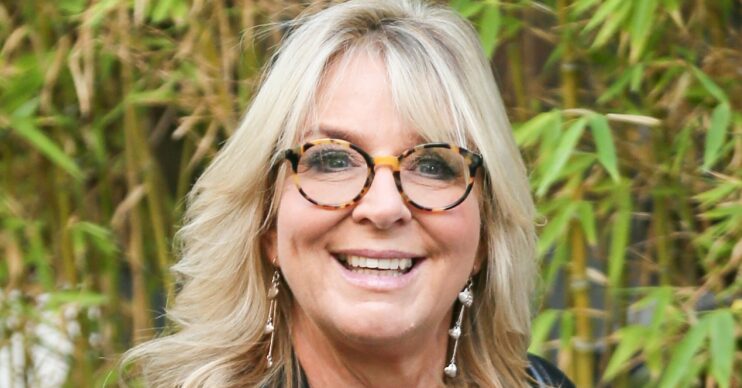 Fern Britton smiles in glasses outside ITV Studios