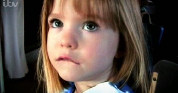 Madeleine McCann wearing a blue top looking up