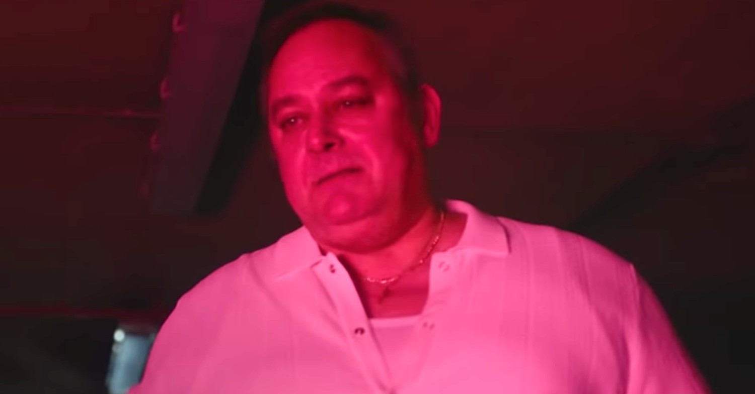 Coronation Street actor Nigel Pivaro grimacing in a red glow in new Irn Bru advert (Credit: YouTUbe)