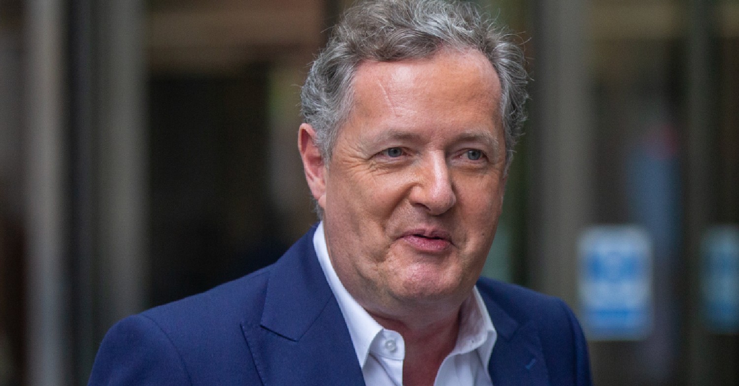 Piers Morgan leaving BBC building in dark blue suit