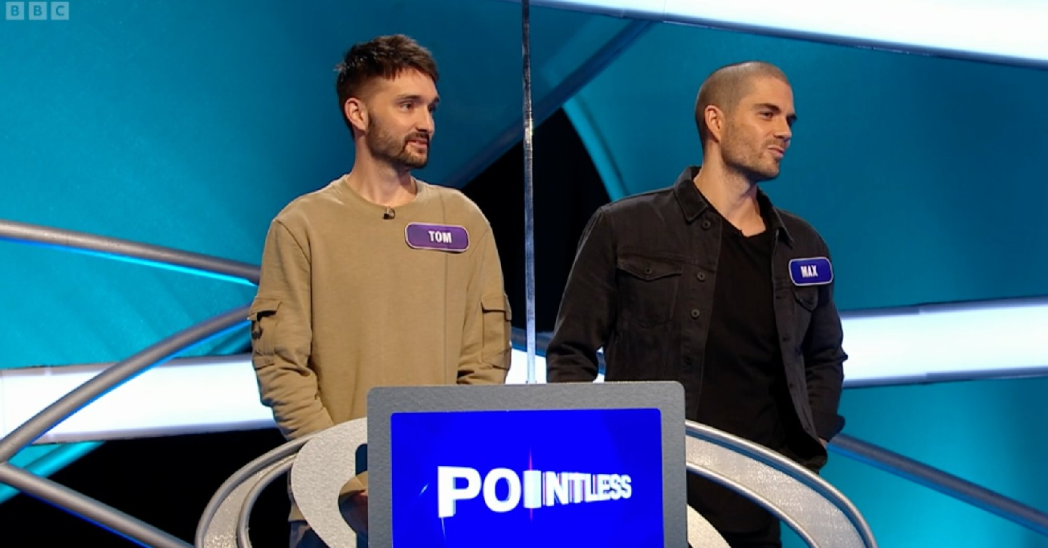 Tom Parker smiling alongside Max George on Pointless