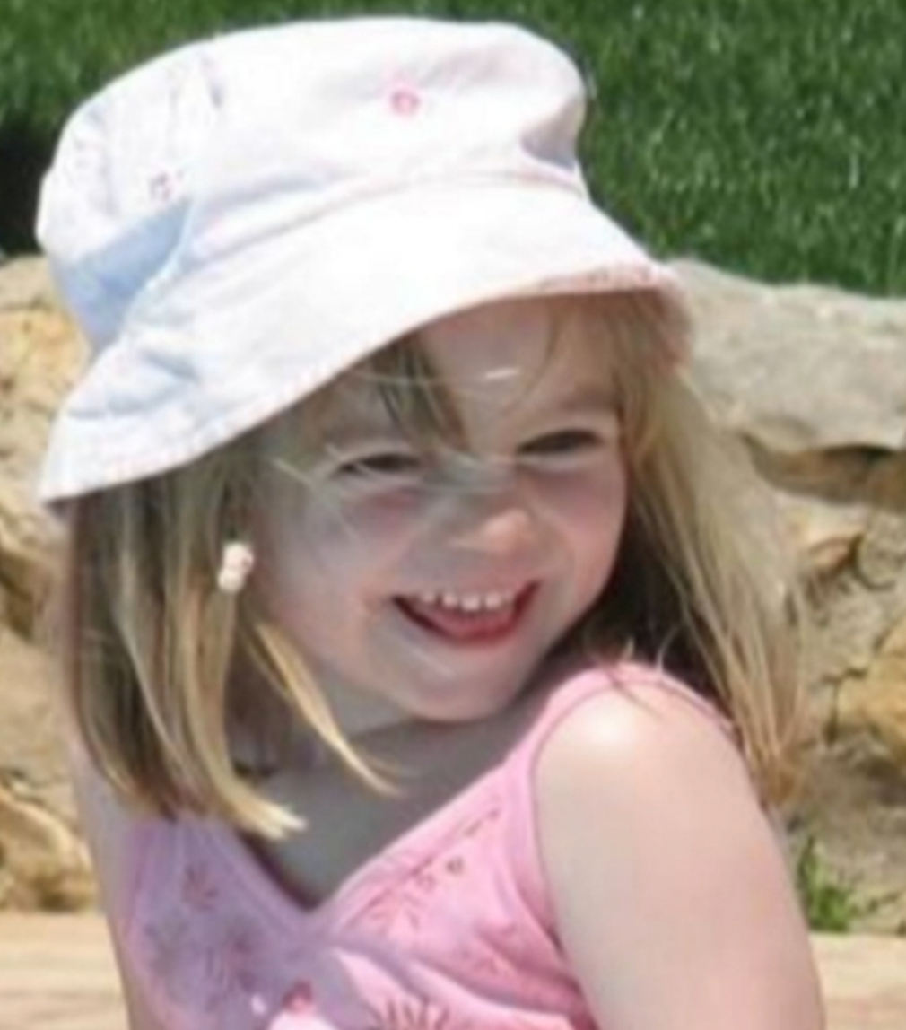 Madeleine McCann smiling wearing a hat