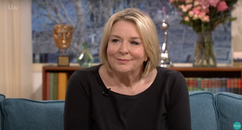Fern Britton smiling weakly as she appears on the This Morning sofa