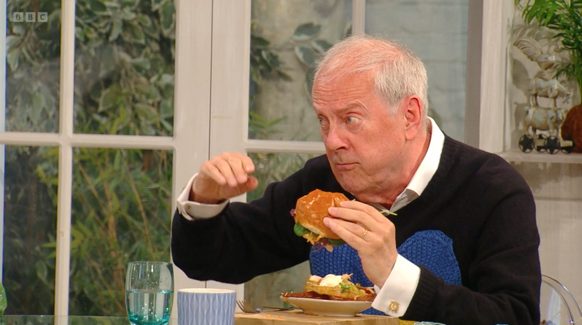 Gyles Brandreth eats a burger on Saturday Kitchen