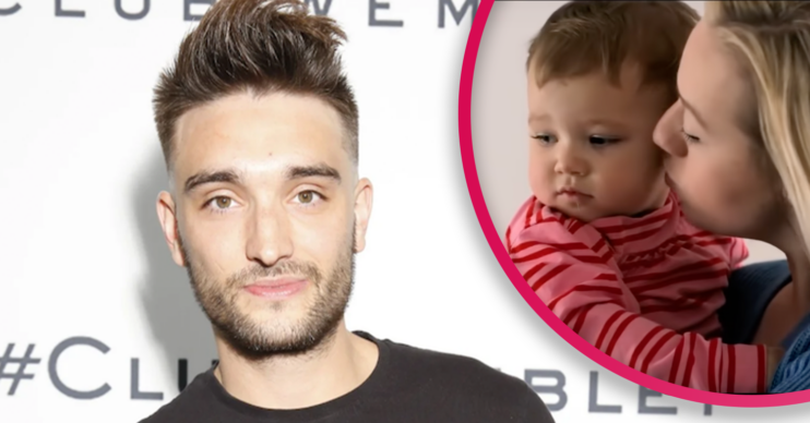 The Wanted's Tom Parker smiling and his wife holding their baby