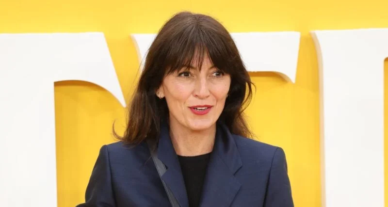 Davina McCall smiling wearing red lipstick