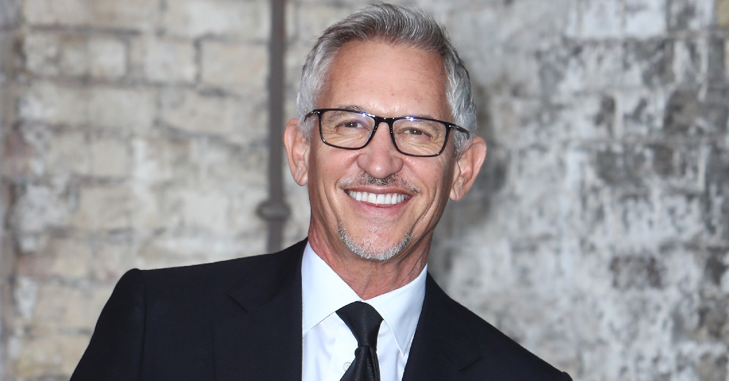 Gary Lineker smiles in black suit and glasses at event