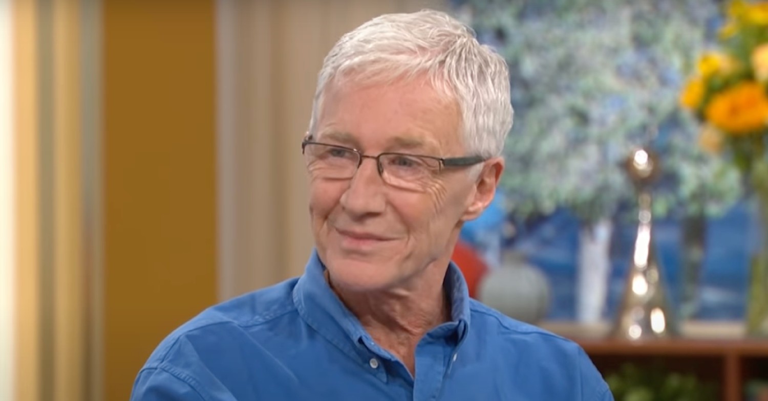 Paul O'Grady smiles on This Morning in blue shirt