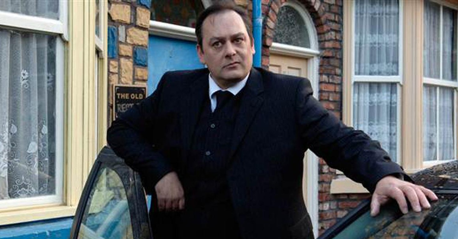 Terry Duckworth frowns as he poses with his hand on a car window (Credit: ITV)