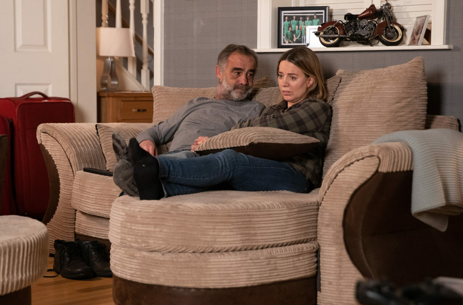 Kevin and Abi Webster cuddle on the sofa in Corrie 
